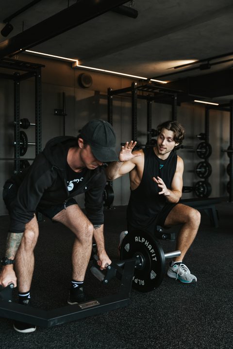 Jamie coaching a client through a lift