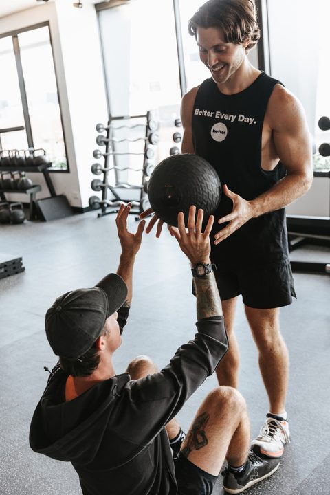 Jamie and a client with a slam ball